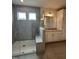 Modern bathroom features a tiled shower with glass enclosure and a vanity with granite countertop at 405 Rising Star Dr, Clayton, NC 27520