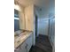 Bathroom featuring granite countertops, vinyl floors, and a modern glass shower with tiled walls at 405 Rising Star Dr, Clayton, NC 27520