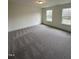 Bedroom with plush carpet, large window, and ample natural light at 405 Rising Star Dr, Clayton, NC 27520