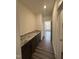 Butler's pantry with granite countertops, dark cabinetry, wood-look floors, and convenient access to the main pantry at 405 Rising Star Dr, Clayton, NC 27520