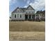 Charming two-story home with a inviting front porch, perfect for relaxing and enjoying the outdoors at 405 Rising Star Dr, Clayton, NC 27520
