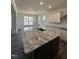 Spacious kitchen island with granite countertop and modern faucet is great for food preparation and gatherings at 405 Rising Star Dr, Clayton, NC 27520
