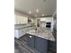 Modern kitchen with white cabinets, stainless steel appliances, and a granite-topped island perfect for cooking and entertaining at 405 Rising Star Dr, Clayton, NC 27520