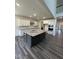 Bright kitchen featuring a large island with a granite countertop, stainless steel appliances and custom cabinets at 405 Rising Star Dr, Clayton, NC 27520