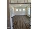 Sunlit living room with pristine hardwood floors, white wainscoting, and inviting atmosphere at 405 Rising Star Dr, Clayton, NC 27520