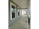 Covered porch featuring neutral siding, white columns, black railings, and an inviting outdoor space at 405 Rising Star Dr, Clayton, NC 27520