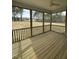 Relaxing enclosed porch overlooking a peaceful backyard, providing a perfect outdoor living space with a ceiling fan at 405 Rising Star Dr, Clayton, NC 27520