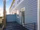 Outdoor deck space with gray wood-look siding, railing, and an exterior door at 4116 Sykes St, Cary, NC 27519