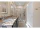 Modern bathroom with double sinks, dark cabinetry, granite countertop, and glass shower at 4116 Sykes St, Cary, NC 27519