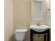 Simple bathroom featuring a modern vanity and toilet in a neutral-colored space at 4116 Sykes St, Cary, NC 27519