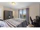 Bedroom featuring a queen bed, neutral walls, and large windows at 4116 Sykes St, Cary, NC 27519
