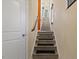Staircase featuring carpet treads and a wooden railing at 4116 Sykes St, Cary, NC 27519
