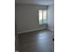 Bedroom with hardwood floors, a window with blinds, and neutral colored walls at 500 Umstead Dr # 105D, Chapel Hill, NC 27516