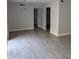 Open-concept living room with light hardwood floors, neutral walls, and modern lighting fixtures at 500 Umstead Dr # 105D, Chapel Hill, NC 27516