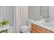 Well-lit bathroom featuring a sink, toilet, bathtub and shower with a white shower curtain at 505 Redford Place Dr, Rolesville, NC 27571