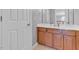 Neutral bathroom with a large vanity and sink plus a door for added convenience and privacy at 505 Redford Place Dr, Rolesville, NC 27571