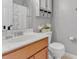 Well-lit bathroom with a white counter and dark wood cabinets at 505 Redford Place Dr, Rolesville, NC 27571