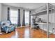 Modern bedroom with a lofted bed, desk area and hardwood floors at 505 Redford Place Dr, Rolesville, NC 27571