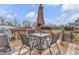 Outdoor deck features seating with an umbrella, offering views of the backyard at 505 Redford Place Dr, Rolesville, NC 27571