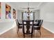 Bright dining room featuring a large table with seating for eight and modern artwork on the walls at 505 Redford Place Dr, Rolesville, NC 27571
