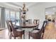 Dining area featuring an elegant table and chairs with bright light coming from the windows at 505 Redford Place Dr, Rolesville, NC 27571