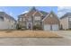 Brick two-story home with arched entry, well-manicured lawn, and a two-car garage at 505 Redford Place Dr, Rolesville, NC 27571