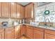 Traditional kitchen featuring granite counters, stainless sink, and dark wood cabinetry at 505 Redford Place Dr, Rolesville, NC 27571