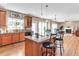 Open kitchen with island with counter seating and view of the breakfast area and living room at 505 Redford Place Dr, Rolesville, NC 27571
