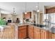 Open kitchen with an island, stainless refrigerator, view to the living room and breakfast area at 505 Redford Place Dr, Rolesville, NC 27571