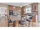 Eat-in kitchen featuring granite countertops, wood cabinets, stainless appliances and center island at 505 Redford Place Dr, Rolesville, NC 27571
