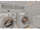 Laundry room featuring a modern washer and dryer with white cabinets and neutral walls at 505 Redford Place Dr, Rolesville, NC 27571