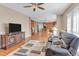 Spacious living room with wood floors, comfortable seating and view into the eat-in kitchen at 505 Redford Place Dr, Rolesville, NC 27571