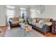 Cozy living room with large windows, hardwood floors, and comfortable seating arrangement at 505 Redford Place Dr, Rolesville, NC 27571