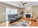 Bright living room with hardwood floors, fireplace and large windows that provide an abundance of natural light at 505 Redford Place Dr, Rolesville, NC 27571