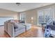 Relaxing living room with hardwood floors, couch and large windows that provide an abundance of natural light at 505 Redford Place Dr, Rolesville, NC 27571