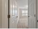 View of a bedroom from the doorway, featuring a window with blinds, carpeting, and neutral colors at 650 Ganyard Farm Way # 4, Durham, NC 27703