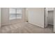 Bedroom with a window offering natural light, closet, and neutral-colored carpet at 650 Ganyard Farm Way # 4, Durham, NC 27703