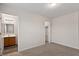 A bright bedroom with a closet and attached bathroom featuring a wood vanity at 650 Ganyard Farm Way # 4, Durham, NC 27703