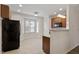 Bright eat-in kitchen featuring tile floors, wood cabinets, and stainless steel refrigerator at 650 Ganyard Farm Way # 4, Durham, NC 27703