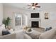 Bright living room features a fireplace, ceiling fan, sliding glass door, and neutral decor at 650 Ganyard Farm Way # 4, Durham, NC 27703