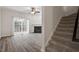 Living room featuring hardwood floors, staircase, fireplace, and sliding glass door at 650 Ganyard Farm Way # 4, Durham, NC 27703