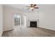 Open living room with hardwood flooring and a fireplace leading to outdoor light through sliding glass doors at 650 Ganyard Farm Way # 4, Durham, NC 27703