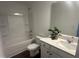 Bathroom with white vanity, tub with shower, and neutral-toned flooring creating a calming retreat at 6814 Galloway Dr, Middlesex, NC 27557
