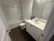 Bathroom with white cabinets, quartz countertops, and a shower-tub combo, complete with modern fixtures at 6814 Galloway Dr, Middlesex, NC 27557