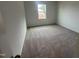 Bedroom featuring neutral carpet and a window, perfect for natural light at 6814 Galloway Dr, Middlesex, NC 27557