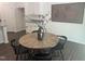 Dining area with a round wooden table, black chairs, and neutral decor, creating an inviting space at 6814 Galloway Dr, Middlesex, NC 27557