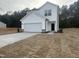 New two story home with a white exterior, concrete driveway, and attached two car garage at 6814 Galloway Dr, Middlesex, NC 27557