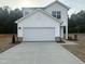 New two story home with a white exterior, concrete driveway, and attached two car garage at 6814 Galloway Dr, Middlesex, NC 27557