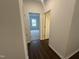Hallway with hardwood floors gives access to bedrooms in this lovely new home at 6814 Galloway Dr, Middlesex, NC 27557