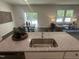Modern kitchen with island sink and granite countertops, open to dining and living areas at 6814 Galloway Dr, Middlesex, NC 27557
